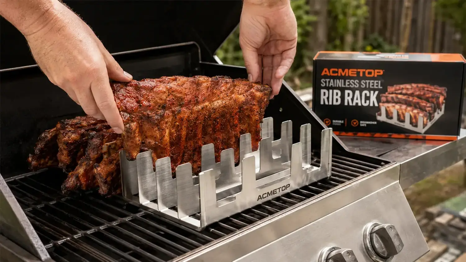 ACMETOP stainless steel rib rack holding two slabs of ribs on a gas grill with the lid open