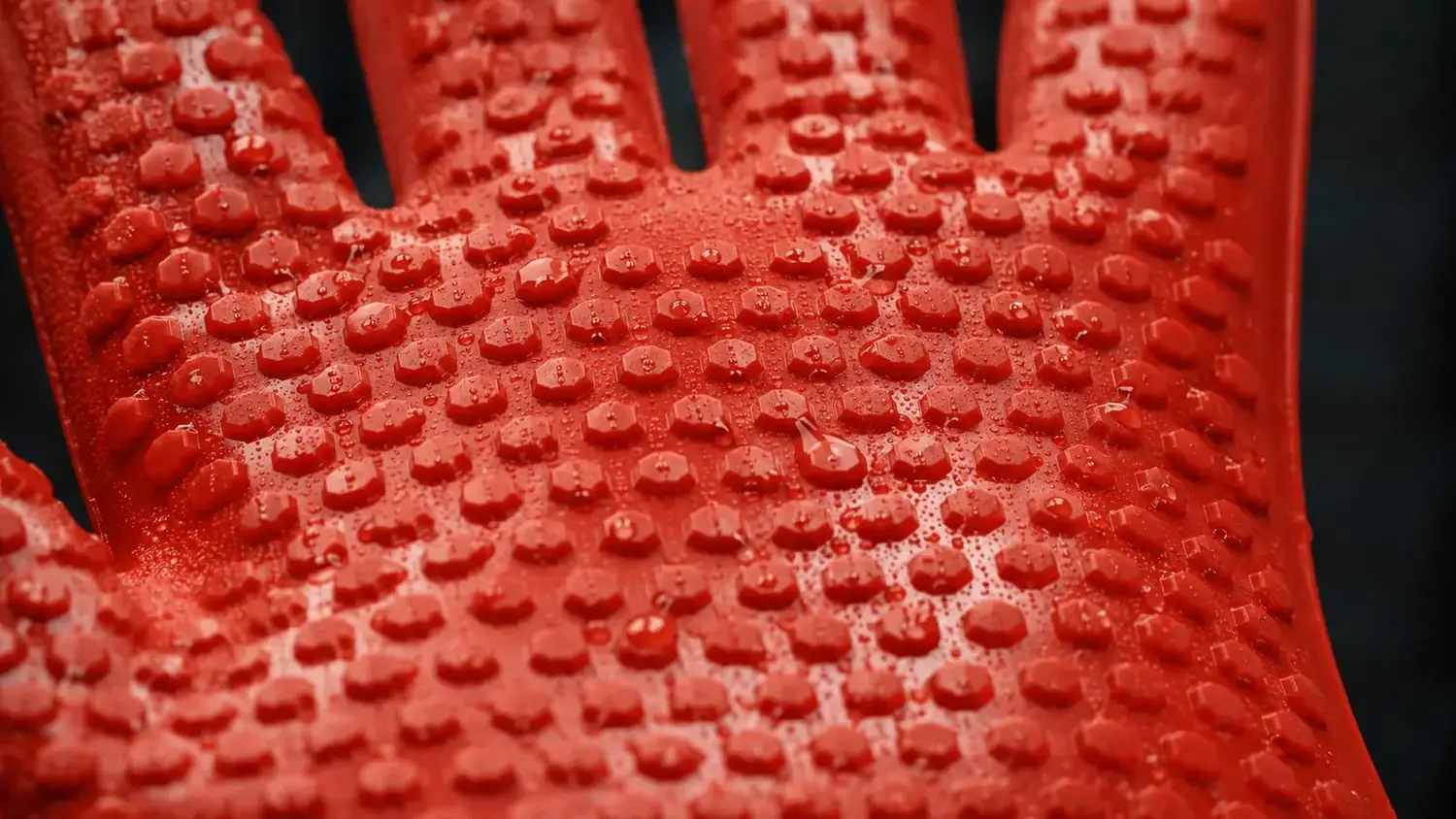 Close-up of silicone BBQ glove after washing, showing intact grip nubs still firmly raised