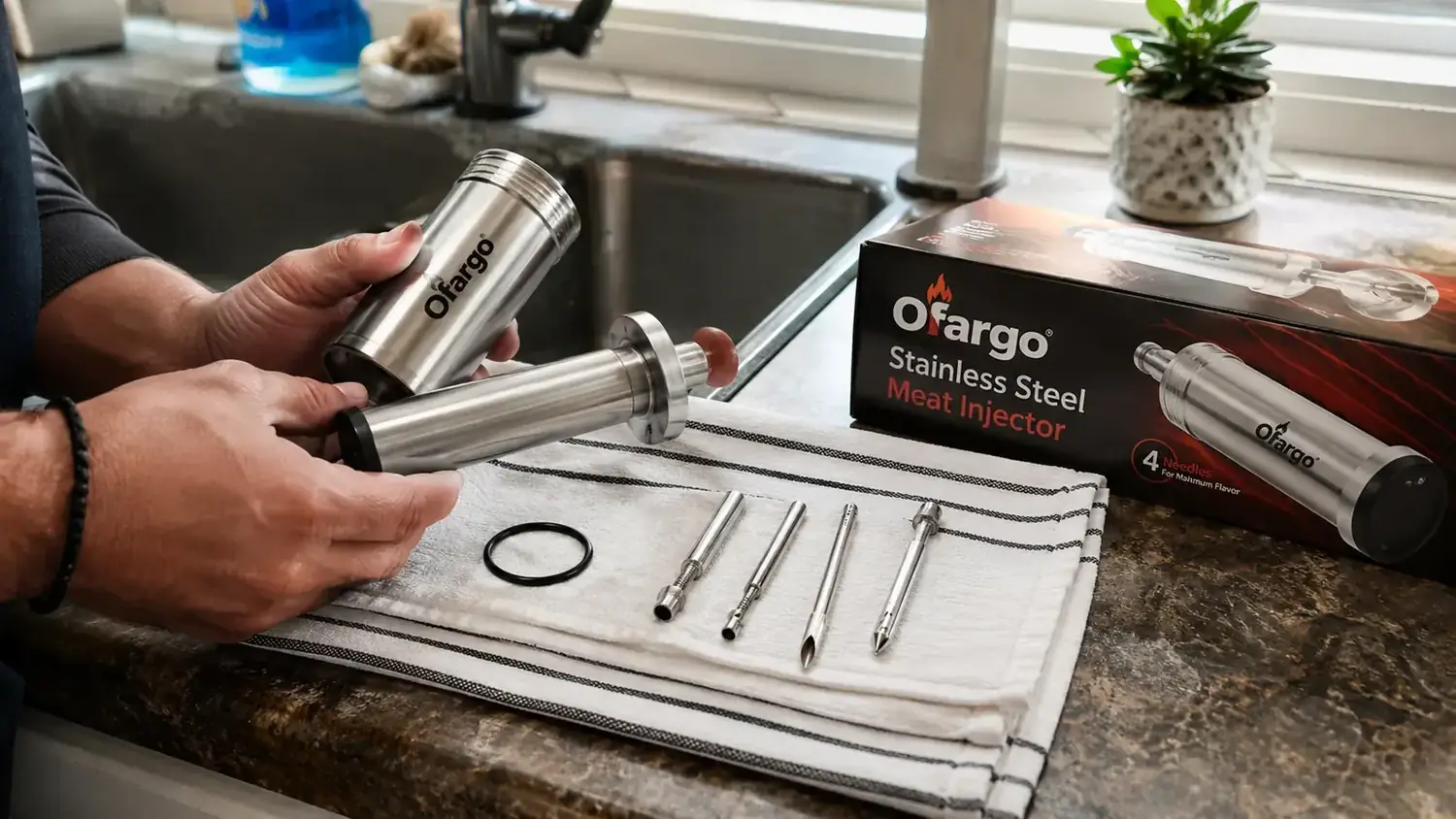 Ofargo injector disassembled for cleaning in a kitchen sink, parts laid out on a dish towel